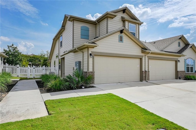 view of front of house featuring fence, concrete driveway, brick siding, a front yard, and a garage