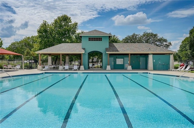 pool with fence and a patio area