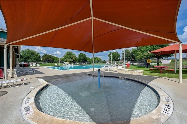 pool with fence and a patio area
