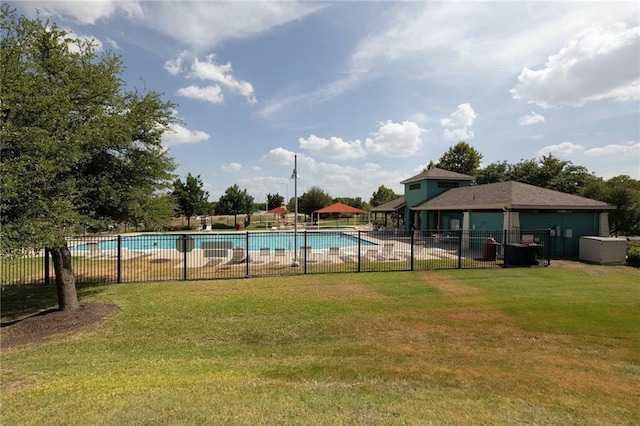 community pool featuring fence and a yard