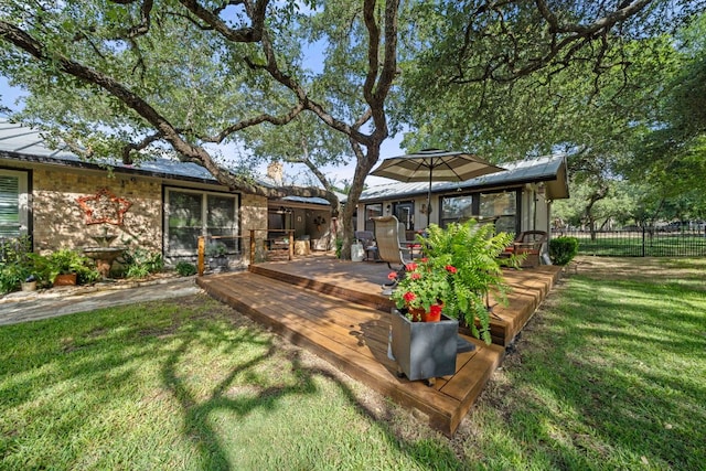 exterior space featuring fence and a deck