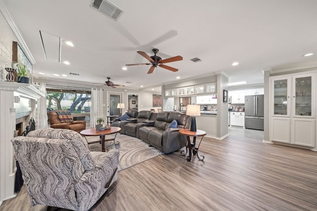 25 Doolittle Dr, Wimberley, TX 78676 - living room with recessed lighting, light wood-type flooring, ceiling fan, crown molding, and attic access