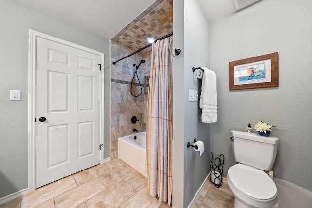bathroom featuring shower / bath combo with shower curtain, toilet, and baseboards