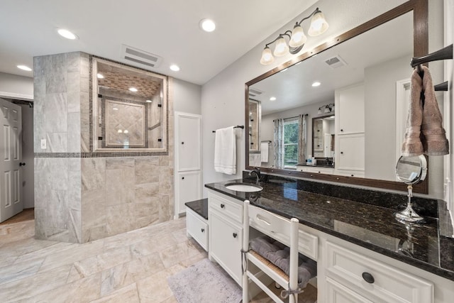 full bath with a walk in shower, recessed lighting, visible vents, and tile walls