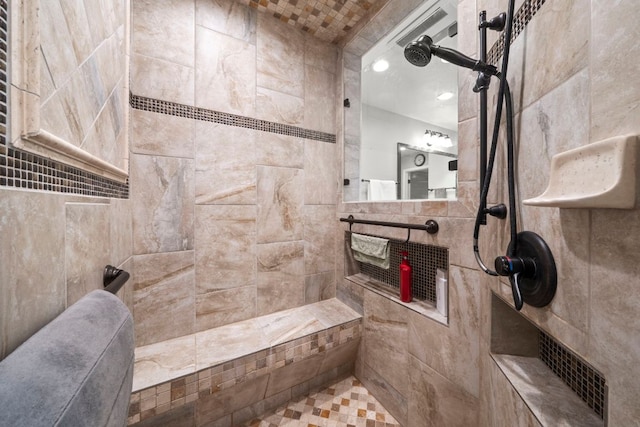 full bath featuring a tile shower, recessed lighting, and tile walls