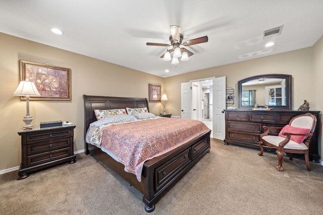 bedroom with ceiling fan, visible vents, baseboards, and light carpet