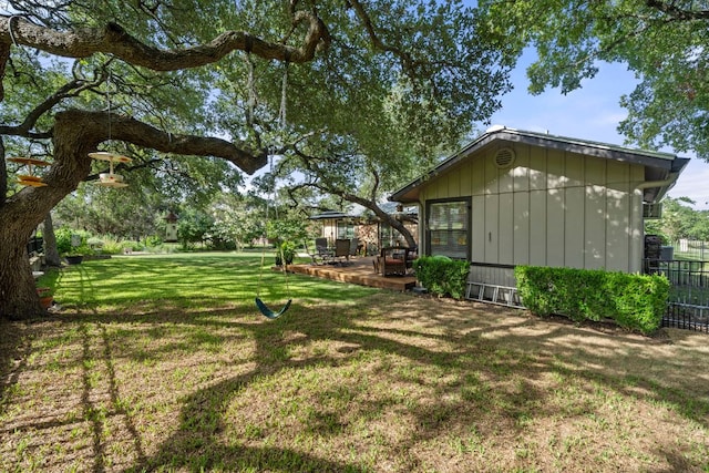 view of yard featuring fence and a deck