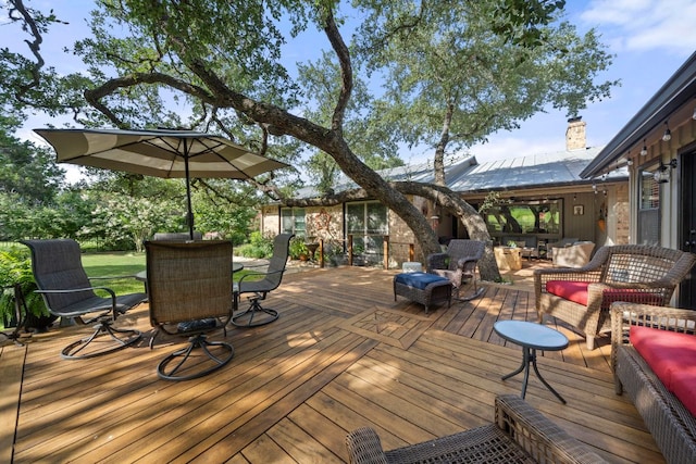 wooden terrace featuring outdoor dining area and outdoor lounge area