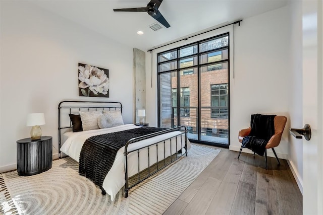 1501 E 4th St Unit 206, Austin, TX 78702 - bedroom featuring access to exterior, wood finished floors, floor to ceiling windows, recessed lighting, and a ceiling fan