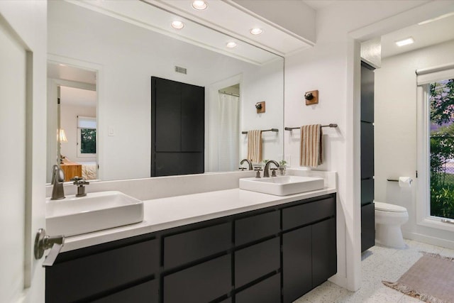 1213 Falcon Ledge Dr, Austin, TX 78746 - bathroom with recessed lighting, double vanity, and healthy amount of natural light