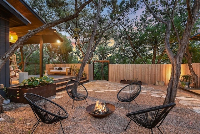 1213 Falcon Ledge Dr, Austin, TX 78746 - fenced backyard with an outdoor living space with a fire pit