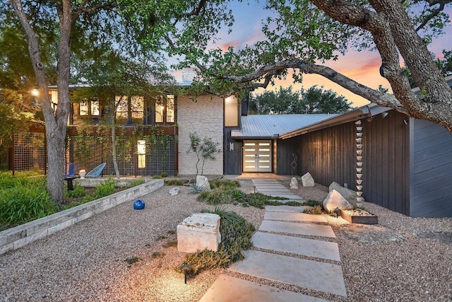 1213 Falcon Ledge Dr, Austin, TX 78746 - view of front facade with a metal roof and french doors