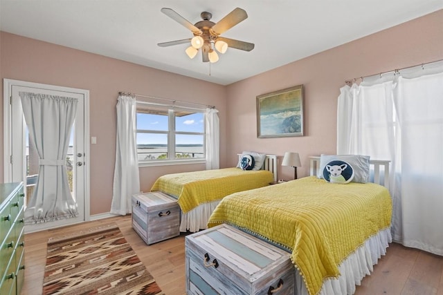 bedroom with light wood-style floors and a ceiling fan
