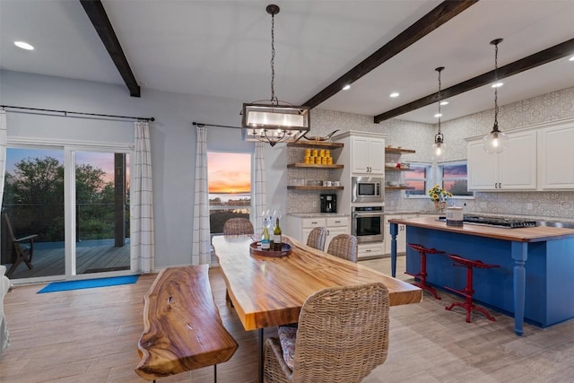 dining space featuring recessed lighting, a notable chandelier, light wood-style floors, and beam ceiling