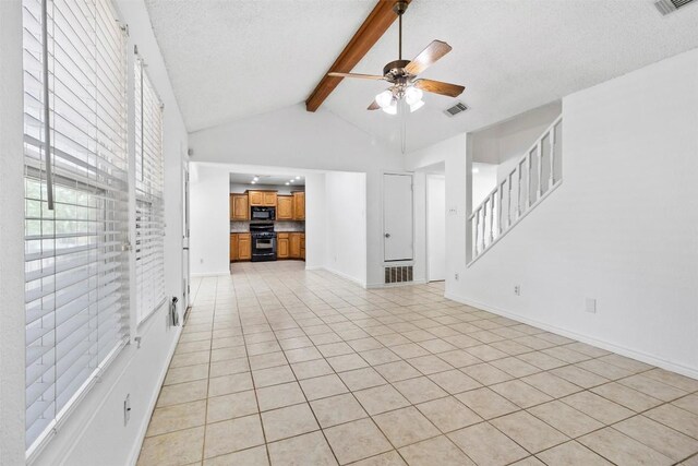 2210 Lasso Dr, Round Rock, TX 78681 - unfurnished living room featuring a textured ceiling, vaulted ceiling with beams, visible vents, ceiling fan, and light tile patterned floors