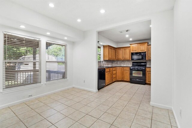 2210 Lasso Dr, Round Rock, TX 78681 - kitchen with light tile patterned floors, visible vents, backsplash, and black appliances