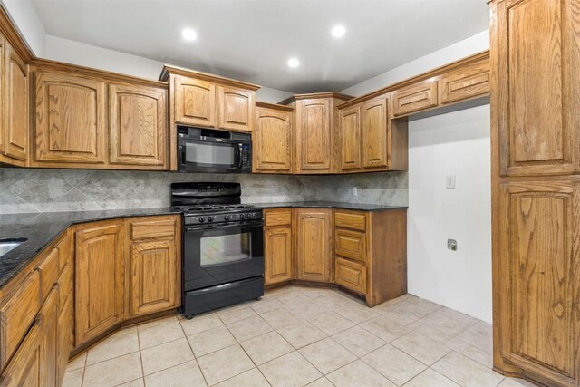 2210 Lasso Dr, Round Rock, TX 78681 - kitchen featuring brown cabinets, backsplash, dark stone countertops, and black appliances