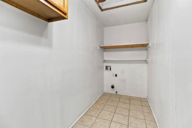 2210 Lasso Dr, Round Rock, TX 78681 - laundry room featuring attic access, hookup for an electric dryer, light tile patterned floors, cabinet space, and washer hookup