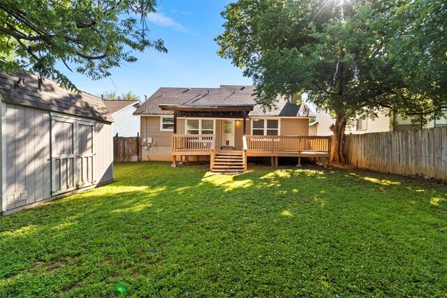 2210 Lasso Dr, Round Rock, TX 78681 - back of house featuring a storage unit, a fenced backyard, a wooden deck, a lawn, and an outdoor structure