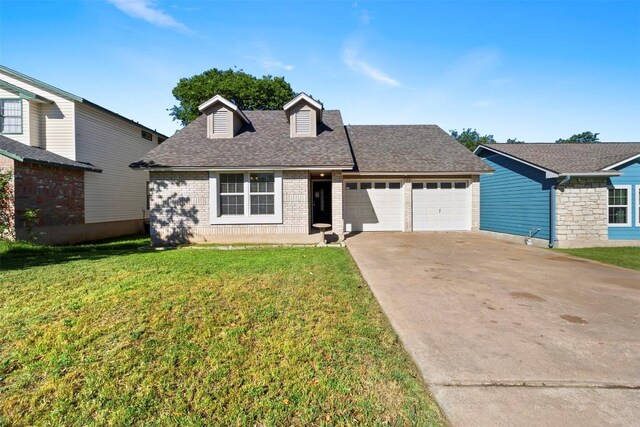 2210 Lasso Dr, Round Rock, TX 78681 - view of front facade featuring a shingled roof, driveway, brick siding, a front yard, and a garage