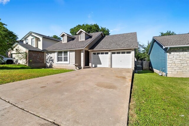 2210 Lasso Dr, Round Rock, TX 78681 - view of front of house with concrete driveway, brick siding, a front yard, and a garage