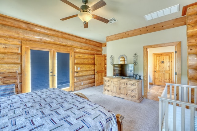 carpeted bedroom with french doors, visible vents, and rustic walls