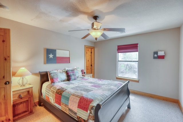 bedroom featuring visible vents, light carpet, a ceiling fan, and baseboards