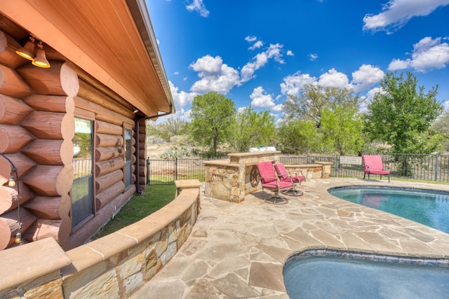 view of pool featuring fence, a patio area, an outdoor stone fireplace, and a fenced in pool