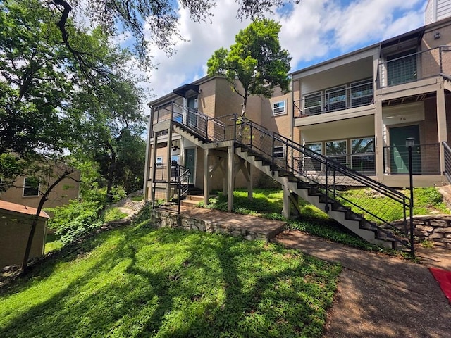 6600 Valleyside Rd Unit 24, Austin, TX 78731 - rear view of property with stairway and stucco siding