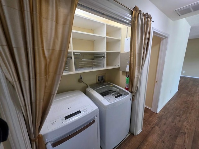 6600 Valleyside Rd Unit 24, Austin, TX 78731 - washroom featuring washer and clothes dryer and dark wood-style flooring