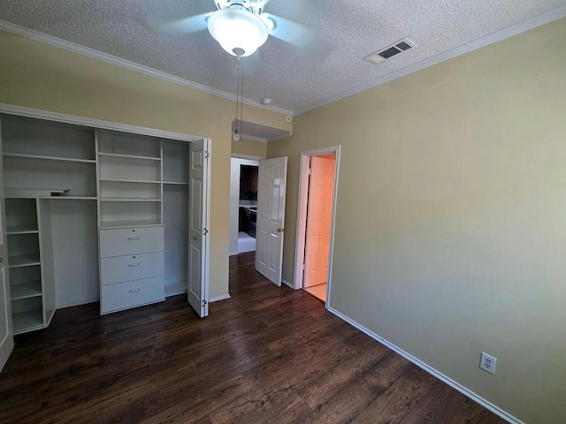 6600 Valleyside Rd Unit 24, Austin, TX 78731 - unfurnished bedroom with a textured ceiling, dark wood finished floors, a closet, crown molding, and a ceiling fan