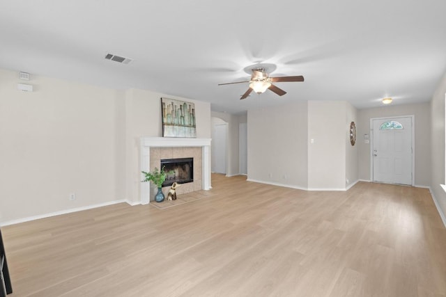 unfurnished living room featuring baseboards, a ceiling fan, visible vents, and light wood-style floors