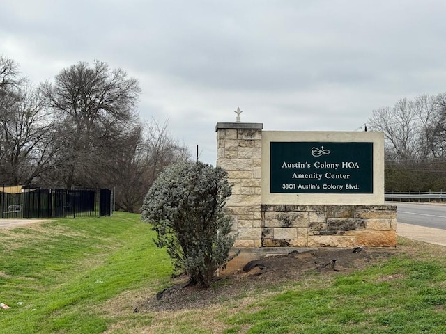 community / neighborhood sign with fence