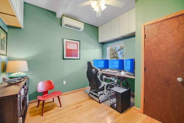 office space featuring a ceiling fan, light wood-style floors, beam ceiling, baseboards, and a wall mounted AC
