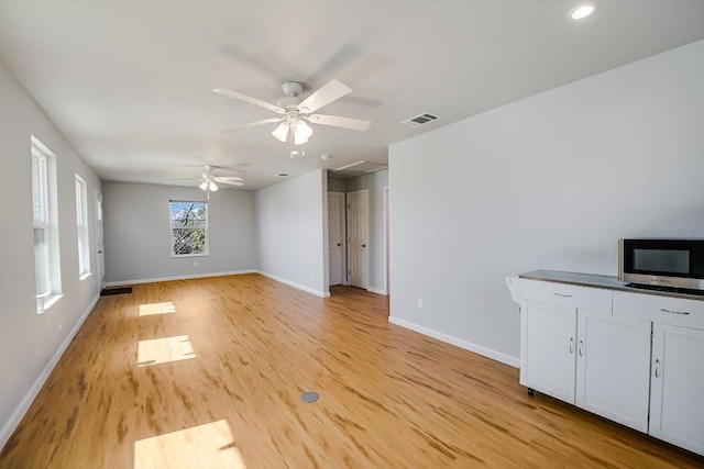 unfurnished living room with light wood-type flooring, baseboards, visible vents, recessed lighting, and a ceiling fan