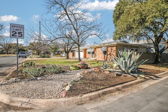 view of front of home featuring fence and a front yard