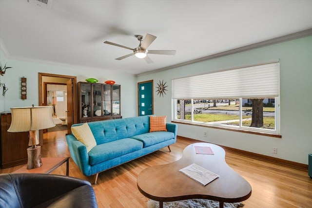 living room with ceiling fan, baseboards, wood finished floors, and ornamental molding