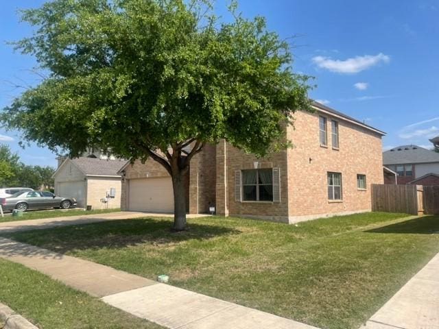 903 Grand Teton Trl, Taylor, TX 76574 - view of home's exterior with concrete driveway, brick siding, and a garage