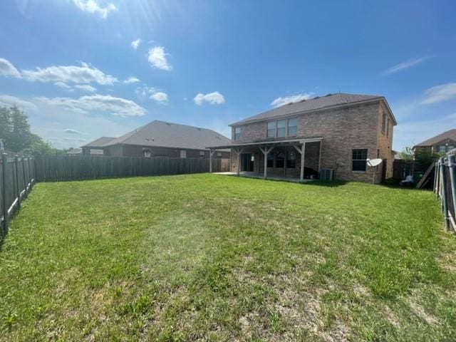 903 Grand Teton Trl, Taylor, TX 76574 - back of house featuring central AC, brick siding, and a patio