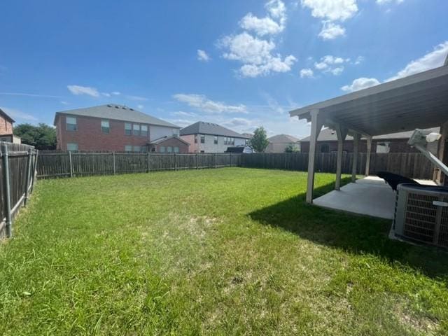 view of yard with a fenced backyard, cooling unit, and a patio