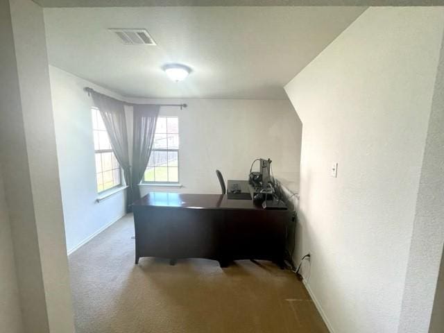office space featuring baseboards, visible vents, and carpet flooring