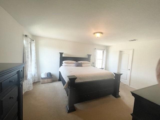 bedroom with carpet floors and visible vents