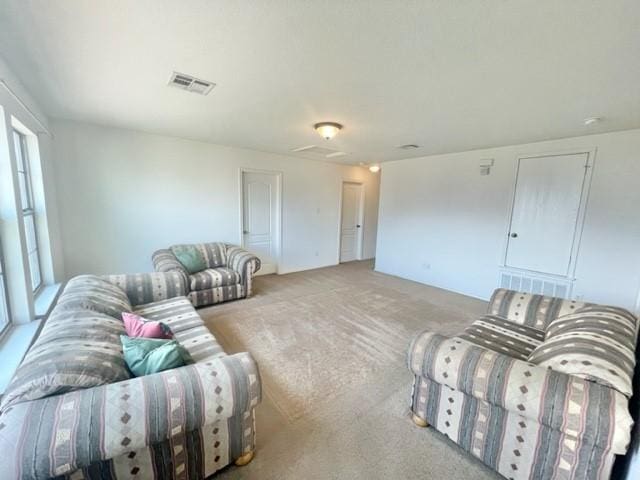 living area with carpet floors and visible vents