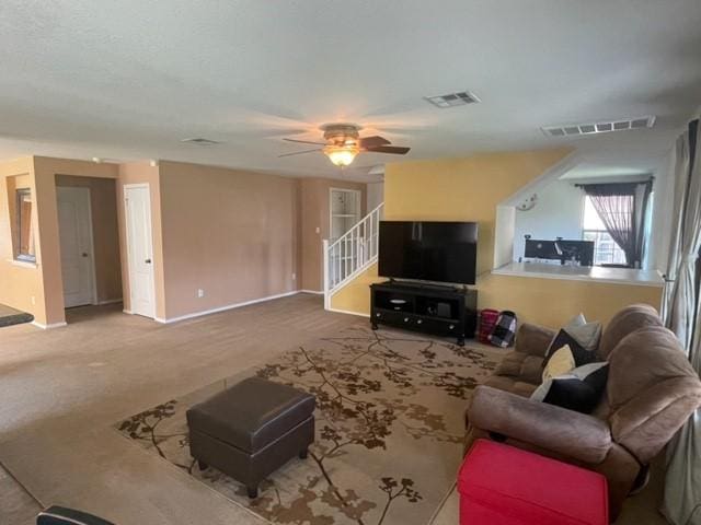 903 Grand Teton Trl, Taylor, TX 76574 - carpeted living area with baseboards, a ceiling fan, and stairway