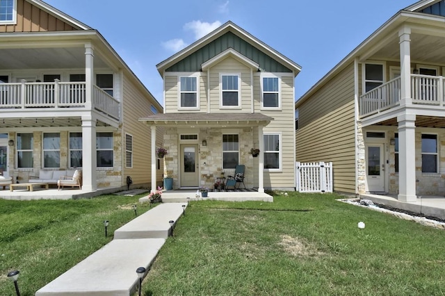 184 Martha Ln, Kyle, TX 78640 - view of front facade featuring board and batten siding, a balcony, a patio area, and outdoor lounge area