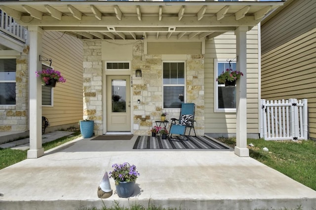 184 Martha Ln, Kyle, TX 78640 - doorway to property featuring covered porch and stone siding
