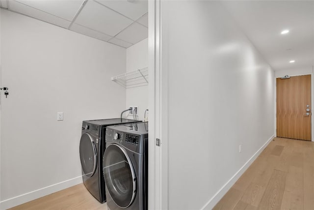44 E Ave Unit 3107, Austin, TX 78701 - laundry area featuring independent washer and dryer, baseboards, light wood-type flooring, and recessed lighting