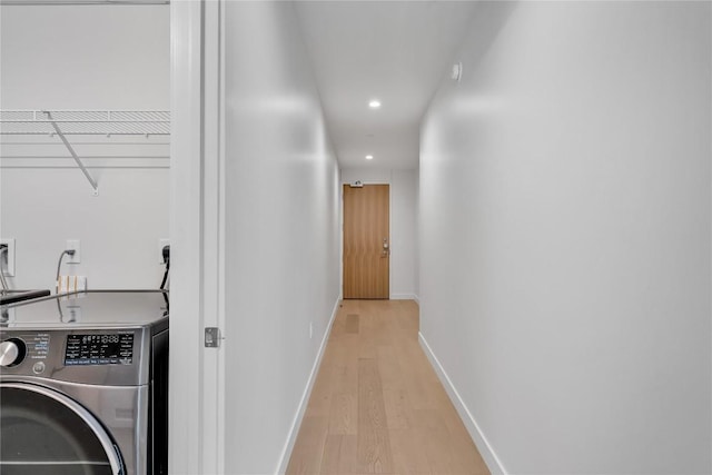 44 E Ave Unit 3107, Austin, TX 78701 - laundry room with washer / dryer, light wood finished floors, recessed lighting, and baseboards