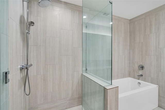 44 E Ave Unit 3107, Austin, TX 78701 - bathroom with a tile shower and a tub to relax in