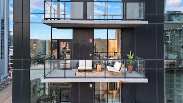 back of house with a city view and a balcony